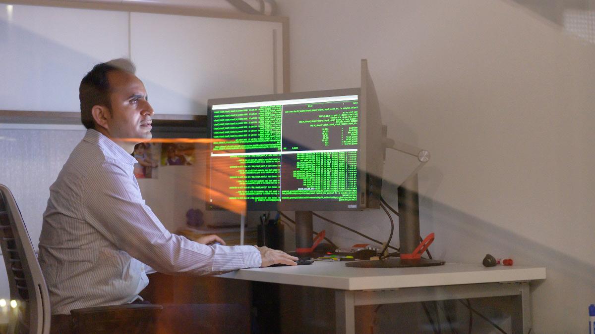 Researcher examining data on computer screen